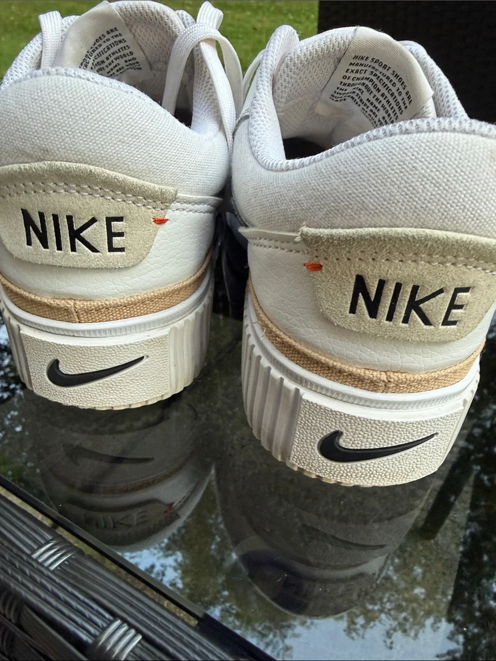 Nike White Sneakers with Black Swoosh and Small Red Logo